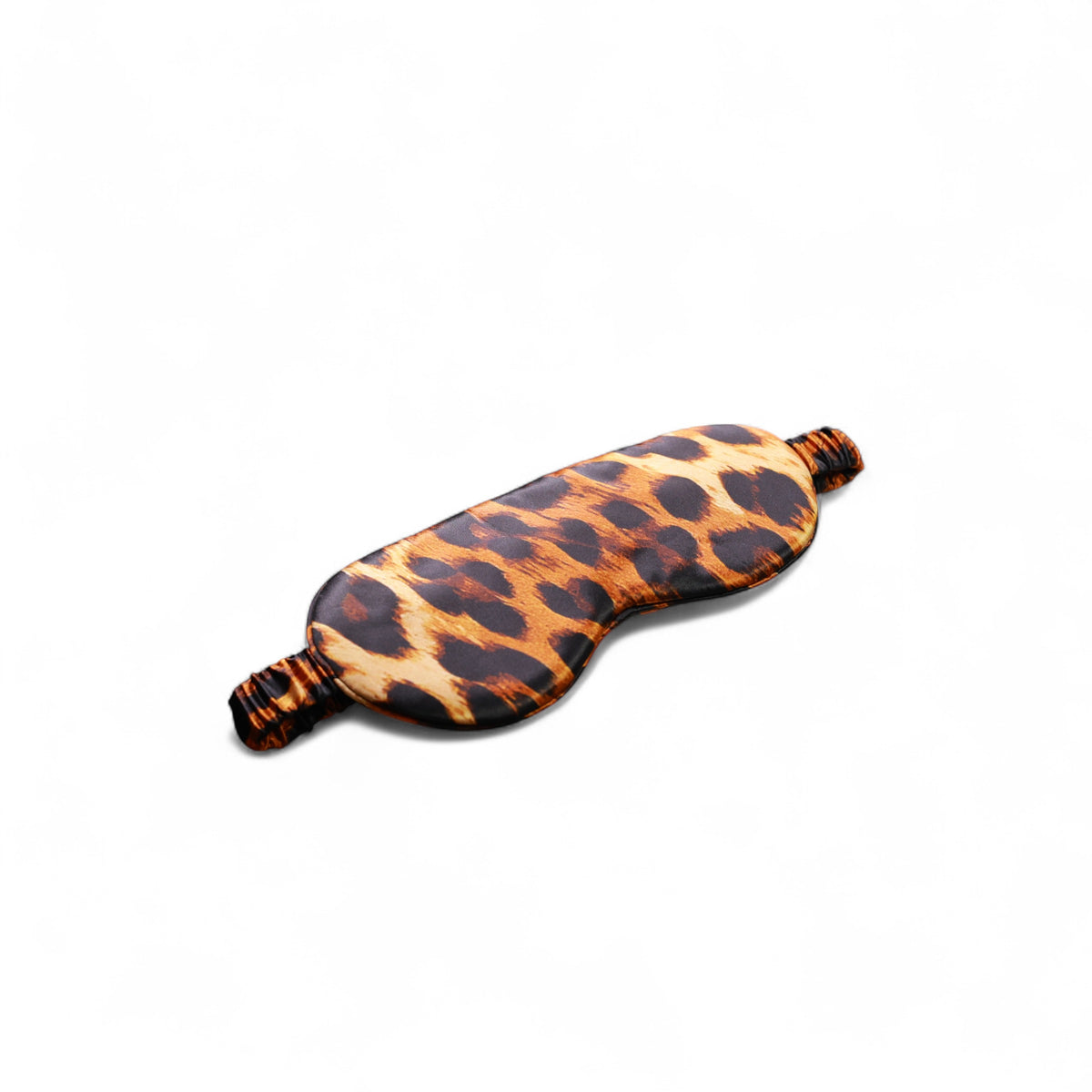 Leopard print organic silk sleep mask on a white background, angled view