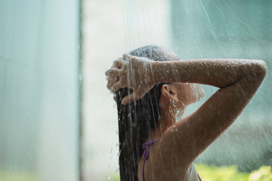 Woman with long hair enjoying an outdoor shower.