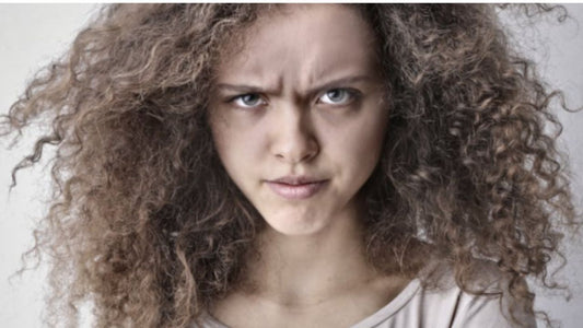 An image of a woman with frizzy curly hair.
